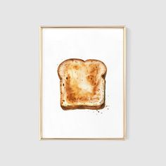 a watercolor painting of a slice of toast on white paper in a gold frame