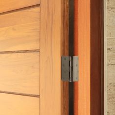 a close up of a wooden door with a metal handle on the outside of it