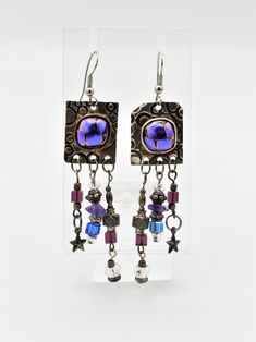 For your consideration, we are offering a unique pair of silver and art glass earrings, featuring tiny silver beads and charms. Signed LP by the maker. Weight: 14.65 grams Length: 3 1/4 inches over all Width: 3/4 inch Hallmarks: LP ** Due to USPS changes, standard shipping may take a few extra days.  If you would like a faster delivery time, we have added a new express shipping option.** Please feel free to reach out with any questions you might have about this item. **Please Note ~ The props used for photos will not be included.** We test all our vintage jewelry for karat content as well as gem testing when applicable. We use the Niton DXL Precious Metal Analyzer for metal purity, and for gem testing, we use the Presidium gem tester.  Furthermore, we tend to leave most jewelry as we recei Nickel-free Metal Fusion Jewelry, Nickel-free Artisan Metal Beaded Earrings, Iridescent Sterling Silver Dangle Earrings, Artisan Metal Beaded Earrings Nickel Free, Fusion Style Dangle Jewelry For Jewelry Making, Glass Jewelry With Dangling Beads, Glass Dangle Jewelry With Dangling Beads, Unique Glass Jewelry With Matching Earrings, Nickel-free Silver Fusion Earrings