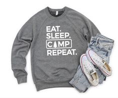 Sweatshirt Details: Eat Sleep Camp Repeat, White Design Available on Gray, Bella Canvas DESIGN IS pressed using a heat press and screen print transfer. Pre-laundered sponge fleece 1x1 ribbed cuffs and waistband Side-seamed Retail fit Pre-shrunk Tear away label Ships via USPS . Outdoor Logo Print Crew Neck Sweatshirt, Outdoor Crew Neck Sweatshirt With Logo Print, Long Sleeve T-shirt With Letter Print For Camping, Crew Neck Cotton Sweatshirt For Camping, Cotton Letter Print Sweatshirt For Outdoor Activities, Crew Neck Sweatshirt For Camping, Cotton Crew Neck Sweatshirt For Camping, Cotton Sweatshirt With Letter Print For Outdoor, Cotton Sweatshirt With Letter Print For Outdoor Activities