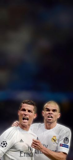 two soccer players with their mouths open in front of the camera on a dark background