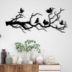 the birds are sitting on the tree branch wall art