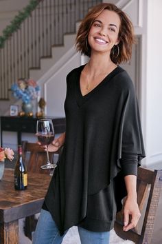 An easy-elegant tunic with cape-like overlay on one side, V-neck and raglan sleeves. Elegant Spring Cape Top, Elegant Cape Top For Spring, Elegant Fall V-neck Tunic, Elegant V-neck Tunic For Fall, Chic Tunic Top For Layering, Chic Asymmetrical Hem Tunic For Layering, Chic Evening Tops With Cape Sleeves, Elegant Evening Poncho For Fall, Elegant Black V-neck Tunic