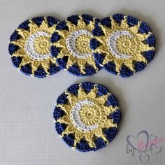 three crocheted coasters with the sun and moon on them, sitting next to each other