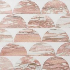 pink and white marble tiles are arranged in an irregular pattern on a wallpapered surface