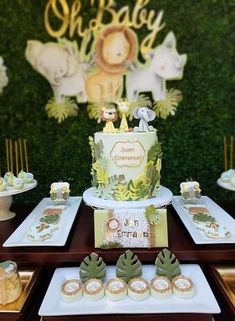 a baby shower cake and dessert table with cupcakes