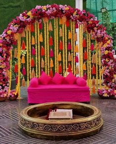 a decorated stage with pink and yellow flowers