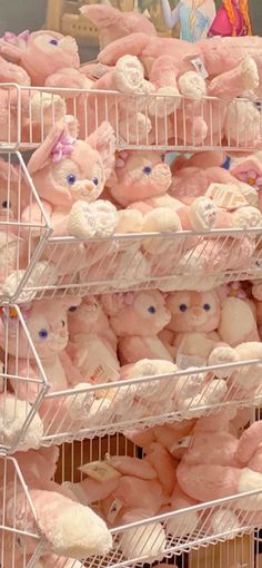 many pink teddy bears are on display in a store