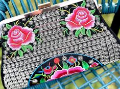 Beautiful Mexican embroidered floral design clutch with cotton strap. Two pockets inside and comes with black removable strap. 11in x 7in Embroidered Evening Bag For Summer, Spring Evening Bag With Detachable Strap, Black Bags With Floral Embroidery For Spring, Spring Evening Clutch With Removable Pouch, Spring Evening Clutch With Detachable Strap, Summer Embroidered Pouch Clutch, Chic Embroidered Summer Clutch, Spring Embroidered Handheld Shoulder Bag, Spring Multicolor Floral Embroidered Shoulder Bag