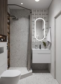 a bathroom with a toilet, sink and shower in it's own area that has a round mirror on the wall