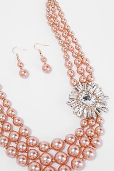 Elevate your look with the Giselle 3 Line Pearl Rhinestone Necklace Set. Its delicate design features three rows of lustrous pearls intertwined with sparkling rhinestones. Perfect for formal occasions or adding a touch of elegance to any outfit. Expertly crafted for a sophisticated and timeless look. SizeL: 18.5"Ex: 3" QualityMade with quality Materials for endurance. ImportedNPY151 Glamorous Beaded Pearl Necklace, Elegant Pink Rhinestone Necklace, Elegant Pearl And Rhinestone Beaded Necklace, Elegant Pearl And Beaded Rhinestone Necklace, Elegant Beaded Pearl Rhinestone Necklace, Formal Beaded Pearl Rhinestone Necklace, Glamorous Pearl Beaded Jewelry, Delicate Design, Rhinestone Necklace