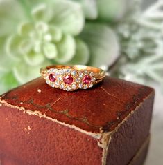 Vintage 18ct Gold, Ruby & Diamond Ring.  Hallmarked London 1983, Makers Mark J&P Size O (EU 56, US 7.5). Free Resizing Available - please message or email info@sobellejewellery.com Weight: 3.9g Rubies: 3 x 2mm Diamonds: 22 x 1mm Condition:  Good, clean vintage condition. All items will have a full professional clean and polish upon dispatch.  My items are all vintage so please study the photographs where I try to show as much detail as possible. Any damage or obvious imperfections will be clearl Formal Oval Ruby Ring With Single Cut Diamonds, Oval Ruby Rings With Single Cut Diamonds, Classic Ruby Ring With Rose Cut Diamond Cluster, Exquisite Yellow Gold Diamond Ring With Gemstone, Exquisite Diamond Multi-stone Cluster Ring, Exquisite Multi-stone Diamond Cluster Ring, Exquisite Diamond Cluster Ring With Multi-stone, Yellow Gold Ruby Rings With Single Cut Diamonds, Vintage Ruby Rings With Single Cut Diamonds