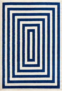 a blue and white rug with an interlocked design on the bottom half of it