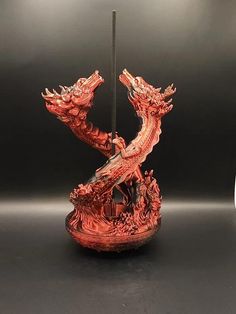 a red dragon statue sitting on top of a table