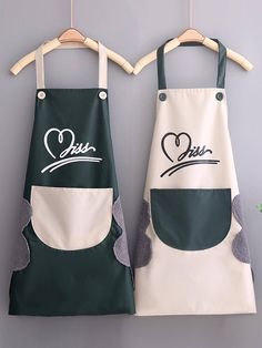 two aprons with the words love and joy written on them hanging from a hanger