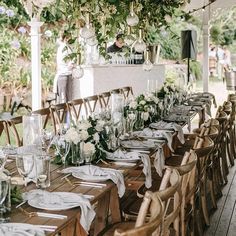 an outdoor dining area with tables and chairs set up for a formal dinner or party