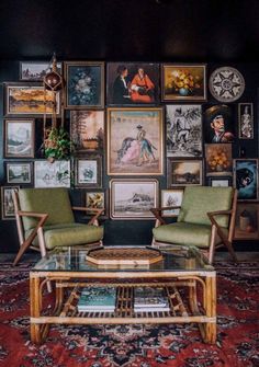 a living room filled with lots of pictures on the wall and two green chairs sitting in front of a coffee table