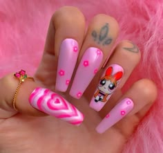 a hand with pink and white nail designs on it