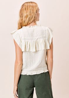 The prettiest bohemian-chic top in multi-textured cotton. Featuring delicate lattice trim inserts, a high neckline, and flirty ruffle details throughout. Flattering and unique, this boho top looks great alone or layered under your favorite cardigan. FINAL SALE Relaxed fit Ruffled cap sleeve Cropped length High ruffled neckline Button front Ruffle details Lattice trim inserts Model is 5'9, wearing a size S.Style: I-12531W-QSD Bohemian Sleeveless Top With Ruffle Hem, Sleeveless Bohemian Top With Ruffle Hem, Bohemian Top With Ruffled Collar, Bohemian Cotton Top With Ruffle Sleeves, Feminine Cotton Tops With Crochet Trim, Bohemian Cotton Tops With Ruffle Sleeves, Bohemian Ruffled Collar Top For Summer, Spring Bohemian Tops With Ruffled Collar, Summer Tops With Lace Trim And Ruffled Collar