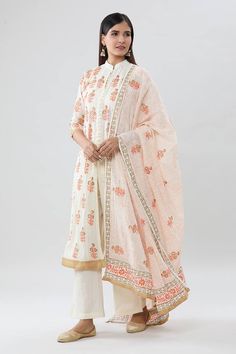 Cream kurta with orange floral block print. Comes with pant and a dupatta - Aza Fashions Chanderi Block Print Lawn Suit For Wedding, Festive Orange Salwar Kameez With Printed Motifs, Orange Chanderi Salwar Kameez With Printed Motifs, Spring Block Print Chanderi Salwar Kameez, Spring Chanderi Block Print Salwar Kameez, White Block Print Sharara For Eid, Orange Anarkali Set With Chikankari Embroidery, Festive Orange Palazzo Set With Printed Motifs, Festival Orange Palazzo Set With Straight Kurta