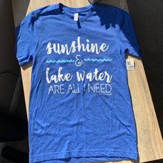 Cute And Simple Lake Life Tee Perfect For Summer Trips Blue Slogan T-shirt For Summer, Blue Summer Top With Text Print, Light Blue Summer T-shirt For Everyday, Blue Tops With Text Print For Summer, Blue Text Print Top For Summer, Trendy Blue Pre-shrunk T-shirt, Blue Cotton Slogan Top, Blue Letter Print T-shirt For Summer, Blue Tops With Text Print For Spring