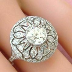 an antique diamond ring is shown on someone's finger