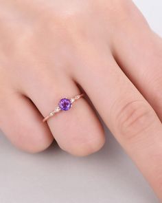 A 5mm round Cut Natural Amethyst ring Accent stone: white CZ The stones of the ring can be replace with other different kinds of gemstone such as morganite, aquamarine, amethyst, citrine, white CZ, pink CZ,etc. If you want to customize your own personal ring, please feel free to contact with me. (925 sterling silver white/yellow/rose gold plated or solid 14k white/yellow/rose gold are available) 14 days money back guarantee. Dazzling Amethyst Diamond Ring For Anniversary, Dazzling Cubic Zirconia Amethyst Wedding Ring, Dainty Round Sapphire Ring With Diamond, Dainty Amethyst Wedding Ring With Prong Setting, Dainty Purple Diamond Jewelry, Classic Purple Diamond Wedding Ring, Fine Jewelry Amethyst Birthstone Ring, Round Cut, Diamond Amethyst Ring For Promise, Amethyst Round Cut Diamond Birthstone Ring