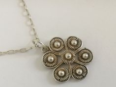 Unique handwork necklace from Bulgaria of 1930s, a little flower on chain. Made in traditional style with famous Bulgarian filigree, traditional Bulgarian jewelry. Made from the whute metal, possibly silver. Very delicate, slim and feminine item, real vintage. Size of the pendant is 2 cm, chain is 45 cm long. Excellent vintage condition. Traditional Necklaces With Vintage Charm And Round Pendant, Vintage Necklaces With Flower Charm Round Pendant, Vintage Necklace With Flower Charm Round Pendant, Vintage Necklace With Round Pendant And Flower Charm, Handmade Ornate Flower Pendant Necklace, Ornate Handmade Flower Pendant Necklace, Vintage Silver Flower-shaped Necklace, Vintage Pendant Necklace With Flower Charm, Vintage Sterling Silver Flower Necklace