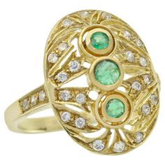 At the heart of this ring lies three mesmerizing round-cut emeralds. Crafted in radiant yellow gold, this vintage-inspired oval filigree ring exudes timeless elegance. The band's shoulders are adorned with diamonds, infusing a touch of luxury. Meticulously placed all over the oval filigree are multiple round small diamonds, enhancing its sparkle and allure. Elevate your hand with a delicate and distinctive ring CHARACTERISTICS Origin: Thailand Metal: Solid 14K Yellow Gold Ring Size: US7 Total Ge Three Stone Ring, Emerald Color, Filigree Ring, Three Stone Rings, Gorgeous Jewelry, Emerald Diamond, Natural Emerald, Vintage Diamond, Three Stone