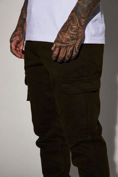 Available InBlack, Khaki, Olive, And Camouflage. Model Height: 6'2 - Waist: 32 - Wearing Large Big & Tall: Height 6'3 - Waist 42 - Wearing XXXL Button Closure Zip Fly Cargo Pants Elastic Hem Front And Back Pockets Cargo Pockets 31 Inseam 98% Cotton 2% Spandex Imported | Mens Kryptonite Cargo Pants in Olive Green size 30 by Fashion Nova Fitted Brown Cargo Pants For Streetwear, Fitted Green Cargo Pants For Streetwear, Military Style Fitted Bottoms For Streetwear, Fitted Military Style Bottoms For Streetwear, Urban Green Cargo Jeans With Hip Pockets, Camouflage Cotton Tapered Leg Bottoms, Fitted Khaki Cargo Pants For Streetwear, Tall Height, Olive Fashion