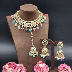 Adorn yourself in timeless elegance with our Multi Color Indian Bollywood Jewelry Set. This exquisite bridal choker necklace, accompanied by delicate earrings and an enchanting tikka, captures the essence of sophistication. Crafted with meticulous attention to detail, the luminous white pearls radiate a sense of purity and grace, making this set a perfect choice for weddings, anniversaries, engagements, and other special occasions. Inspired by the opulence of Bollywood aesthetics, this jewelry s Bollywood Style Jeweled Bridal Earrings, Fusion Style Jeweled Bridal Necklace For Wedding, Chandbali Jeweled Bridal Necklace For Wedding, Festive Kundan Bridal Necklace With Matching Earrings, Jeweled Chandbali Bridal Necklace, Kundan Bridal Necklace With Matching Earrings For Celebration, Traditional Jewelry Sets For Reception With Matching Earrings, Wedding Jeweled Chandbali Bridal Necklace, Bollywood Jeweled Bridal Necklace For Wedding