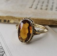 Beautiful 1950s vintage silver citrine ring, US Size 6 3/4, in good vintage condition. Box on the photos not included! Diameter: approx. 15 mm (0.6 inch) Material: 800 silver, citrine total weight: 3.3 g US Size: approx. 6 3/4 (EU size 54) A stunning religious shop well worth a visit ... https://etsy.me/2NNNK4g Vintage Gold Topaz Birthstone Ring, Vintage Yellow Gold Citrine Jewelry, Vintage Citrine Yellow Gold Jewelry, Brown Hallmarked Vintage Ring, Antique Brown Wedding Rings, Vintage Brown Hallmarked Ring, Vintage Brown Hallmarked Jewelry, Antique Topaz Ring As Gift, Antique Topaz Gemstone Ring Gift