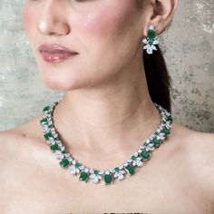 Emerald Diamond Necklace High End Jewelry adds Premium Quality green stone and shiny cubic zirconia. Perfect for wedding jewelry or any special occasions. This green emerald necklace surely add a touch of premium ness in your look. *𝐏𝐑𝐎𝐃𝐔𝐂𝐓 𝐃𝐄𝐓𝐀𝐈𝐋* * 𝐌𝐚𝐭𝐞𝐫𝐢𝐚𝐥: Brass * 𝐏𝐥𝐚𝐭𝐢𝐧𝐠: White Rhodium Plated * 𝐒𝐭𝐨𝐧𝐞: AAA-quality CZ Diamond & Green Onyx. *𝐃𝐈𝐌𝐄𝐍𝐒𝐈𝐎𝐍𝐒* *𝐍𝐞𝐜𝐤𝐥𝐚𝐜𝐞* * 𝐖𝐞𝐢𝐠𝐡𝐭: 75 gm * 𝐋𝐞𝐧𝐠𝐭𝐡: 16.5 Inches * 𝐖𝐢𝐝𝐭𝐡: 0.6 Inches *𝐄𝐚 Luxury Green Bridal Necklace For Celebration, Luxury Green Necklace For Celebration, Traditional Luxury Diamond Emerald Necklace, Luxury Green Jewelry For Promise, Luxury Green Jewelry Set For Celebration, Luxury Green Jewelry For Anniversary, Luxury Diamond Emerald Necklace For Celebration, Luxury Green Bridal Necklace With Diamond Accents, Luxury Diamond Emerald Necklace For Reception