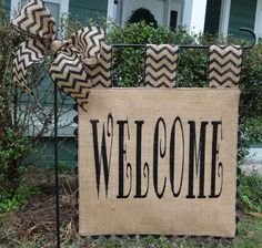 a welcome sign with chevron burlocks on the front door and bow at the top