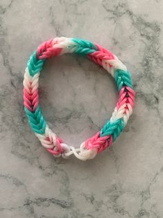 a colorful bracelet sitting on top of a marble counter