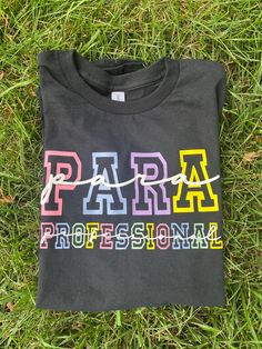 a t - shirt that says paris on it in multicolored letters and string