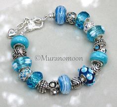 European Style Charm Bracelet "One of a Kind" Beautiful Aquamarine, Lake Blue & Ocean Glass Beads European Crystal Charms Classic and Casual for any Occasion Available In Sizes 7 1/2 ' 8" 8 1/2" 9" each size has 1" additional extension chain *  FREE SHIPPING on orders of $35 or more *  Thank You For Stopping By My Shop           www.muranomoon.com Blue Crystal Bracelet With Spacer Beads, Blue Beaded Bracelets With Polished Beads As Gift, Adjustable Blue Charm Bracelet With Heart Beads, Blue Charm Bracelet With Heart Beads And Adjustable Fit, Blue Polished Beads Bracelets For Gift, Blue Heart Beads Bracelet Jewelry, Blue Heart Beads Bracelet, Blue Crystal Bracelet With Polished Round Beads, Blue Crystal Bracelet With Polished Beads For Gift