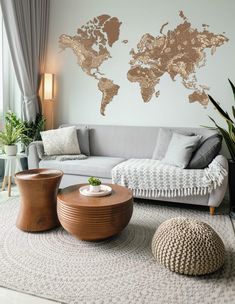 a living room filled with furniture and a large map on the wall above it's couch