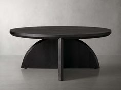 a round table with an unusual design on it's top and bottom, in dark wood