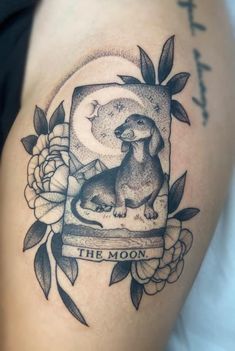 a black and white photo of a tattoo with the moon in it's center