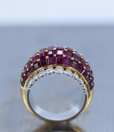 For Sale on 1stdibs - 18 kt. yellow & white gold, 75 square-cut rubies ap. 7.00 cts., 22 round & single-cut diamonds ap. .95 ct., ap. 9.4 dwts. Size 6. Rubies: medium deep raspberry, Luxury Ruby Diamond Ring With Rose Cut Diamonds, Luxury Ruby Halo Ring, Luxury Ruby Ring With Diamond Baguette Cut, Luxury Ruby And Diamond Ring In Yellow Gold, Luxury Ruby Ring With Diamond In Yellow Gold, Luxury Diamond Ruby Ring With Baguette Cut, Luxury Red Diamond Ring With Single Cut Diamonds, Luxury Ruby Ring With Diamond Accents In Yellow Gold, Luxury Yellow Gold Ruby Ring With Diamond Accents