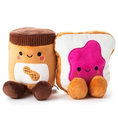 two small stuffed animals sitting next to each other on a white surface and one has a peanut butter sandwich in it