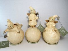 three ceramic figurines sitting on top of each other