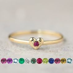 Indulge in sweetness with our natural birthstone heart ring, delicately crafted for everyday wear. Its petite size and simple design make it the perfect complement to any ensemble. Available in 14K solid gold, choose from yellow, rose, or white to suit your style. Stack it with your favorite rings for a personalized touch. Whether it's a gift for yourself or a token of affection for a special someone, this charming ring embodies love and elegance. Perfect for birthdays, anniversaries, or Mother's Day, it's a timeless expression of affection and appreciation. * Heart width x height: ≈5mm x ≈4mm * Band height: ≈1.3mm * Natural birthstone : 2mm * Made of 100% recycled precious metal and ethically sourced gemstone * Comes in a gift box with a bow ready for gifting <> January: Rhodolite Garnet Dainty Heart Shaped Birthstone Promise Ring, Dainty Heart-shaped Promise Birthstone Ring, Dainty Heart Birthstone Promise Ring, Dainty Heart Ring With Birthstone For Anniversary, Minimalist Heart Ring With Birthstone For Gift, Dainty Heart Cut Stackable Rings Gift, Dainty Heart Ring With Birthstone For Promise, Dainty Heart-shaped Birthstone Ring For Anniversary, Dainty Heart-shaped Birthstone Ring For Wedding