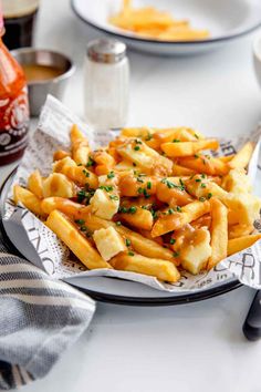 a plate full of french fries on a table