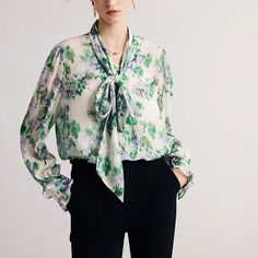 Exquisite Elegance Meets Comfort Discover the epitome of sophistication with our Floral Silk-Blend Bow Collar Blouse, a perfect blend of luxury and practicality for the modern woman. This exquisite piece is designed to elevate your office attire while ensuring comfort and style throughout your day. Its unique blend of high-quality materials and eye-catching design makes it a must-have for any fashion-forward professional. Product Features Fabric Composition: Crafted with 40% genuine Mulberry silk and 60% Viscose, this blouse offers a smooth, luxurious feel against the skin. Charming Floral Print: Adorned with a tasteful floral pattern, it adds a touch of femininity and elegance to your wardrobe. Stylish Bow Collar: The blouse features a chic bow collar, adding a sophisticated and timeless Professional Event, Cardigan Sweater Vest, Professional Wardrobe, Bow Collar, Blouse For Women, Office Attire, Professional Women, Collar Blouse, Ladies Tops Fashion