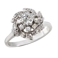 an antique style diamond cluster ring in 18ct white gold, set with round brilliant cut diamonds