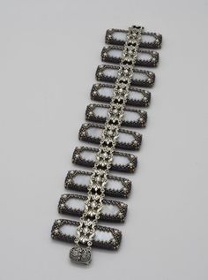 a silver bracelet with black and white stones