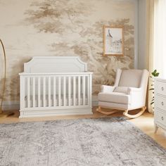 a baby's room with a rocking chair, crib and rug in it