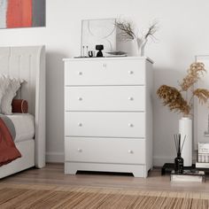 a bedroom with a bed, dresser and pictures hanging on the wall in front of it